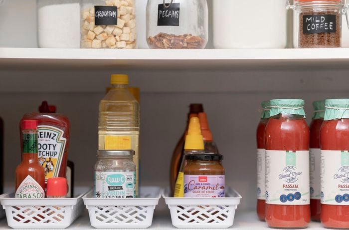 Pantry with baskets full of condiments.