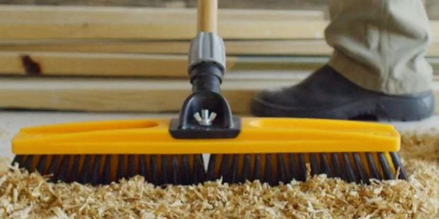Broom sweeping sawdust.