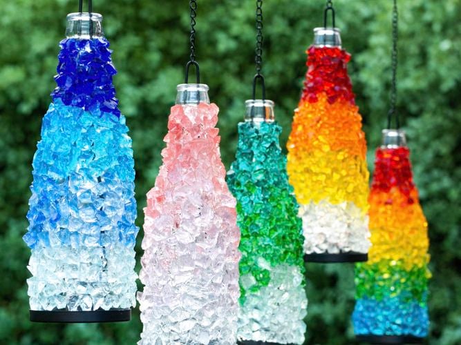 Mandala Art's range of brightly coloured mosaic glass lanterns hanging side by side. Available in DIY kits in the Bunnings craft aisle.
