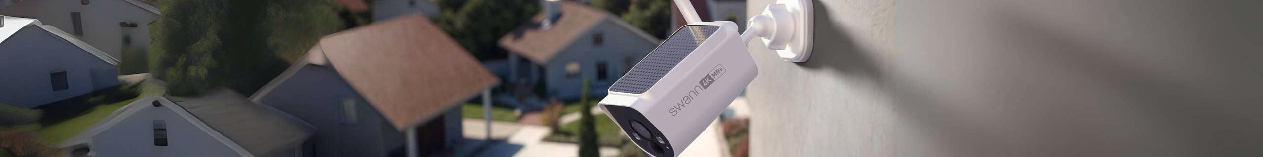 Swann security camera in shot on the wall of a house