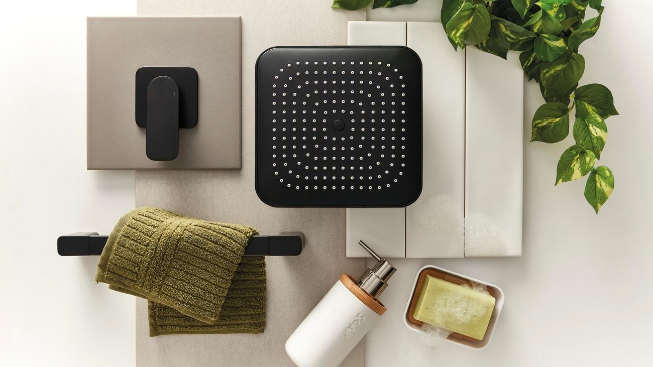 Flatlay image of bathroom fixtures including a showerhead, shower mixer tap, hand towel rail and soap dispenser