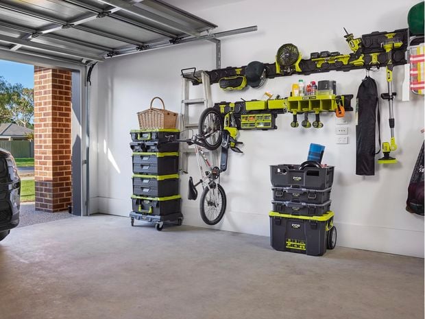 Wall covered in hanging plates and hooks for storing tools.