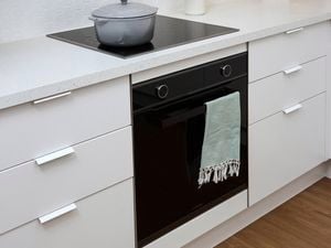 Black kitchen stove & oven in large kitchen display unit at warehouse