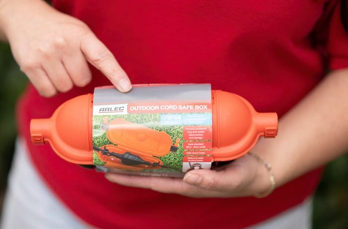 A person is pointing at an Arlec outdoor cord safe box 