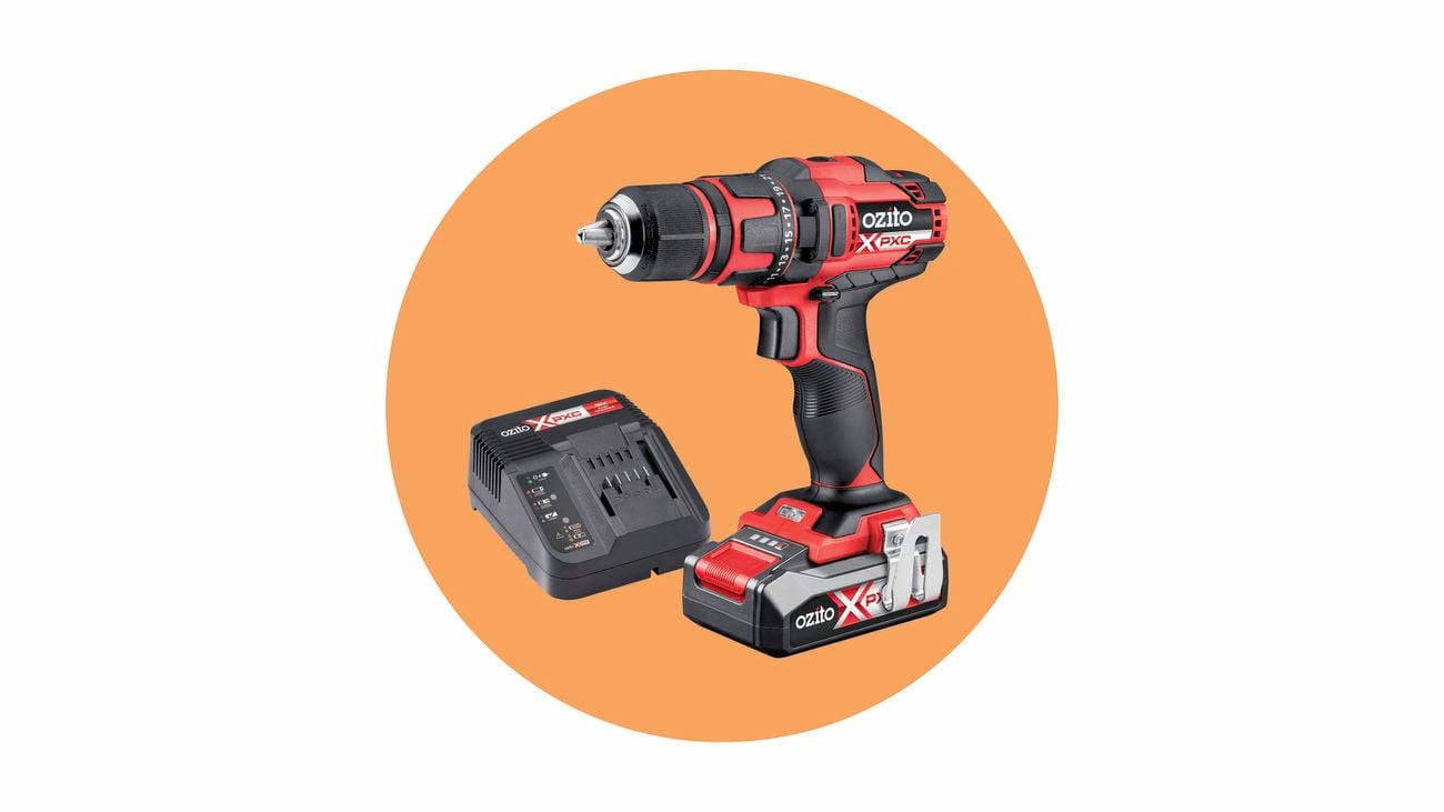 A red and black Ozito cordless drill with a battery and a battery charger.