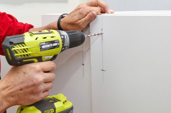 Person drilling holes for handles