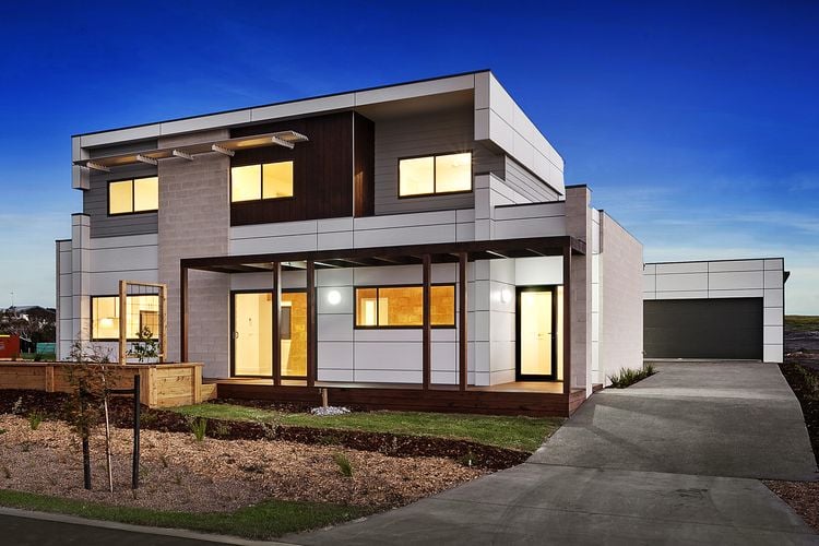 Exterior of a modern two-storey house clad in a range of materials including large white panels