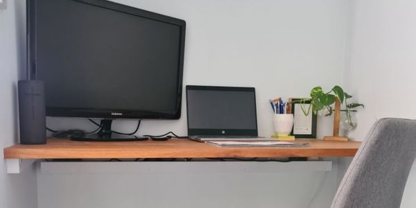 A D.I.Y. floating timber desk and computer with office chair