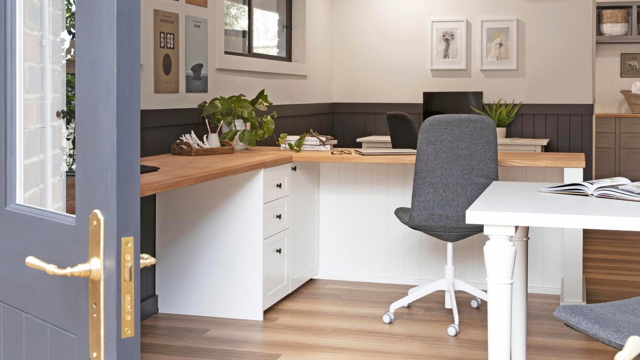 Home office with desk, chair, computer and door