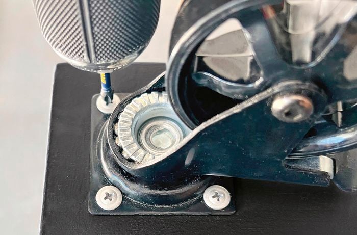 Close up shot of a castor attached to shoe rack.