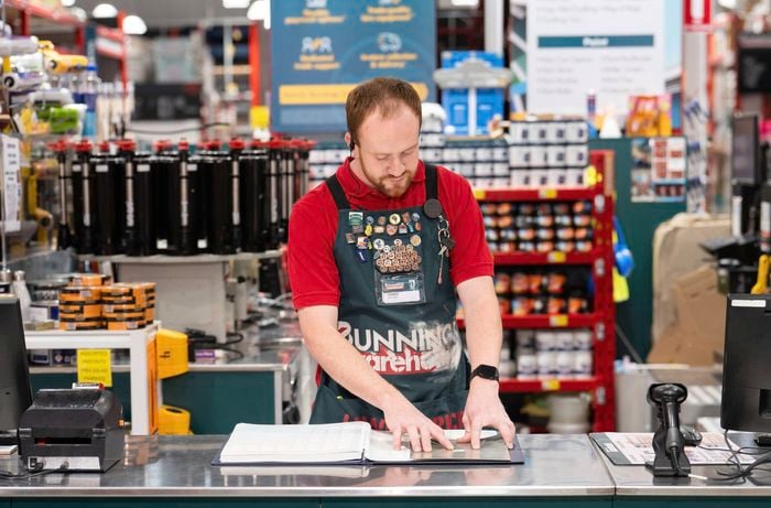 A Bunnings Team Member helping with paint colour matching in store