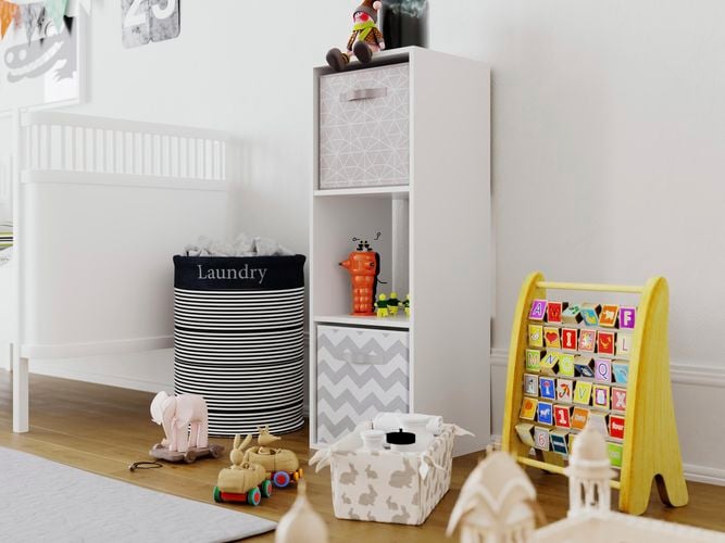 A cube shelving unit, toys and a bed in a children's bedroom