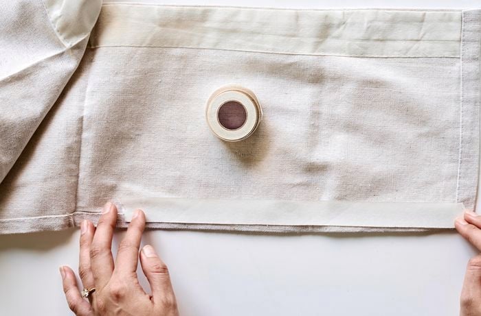 Aerial view of drop sheet, iron-on bonding tape and dressmaking pins