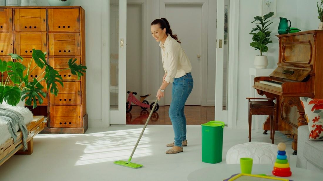 Woman using a sabco mop to mop floors