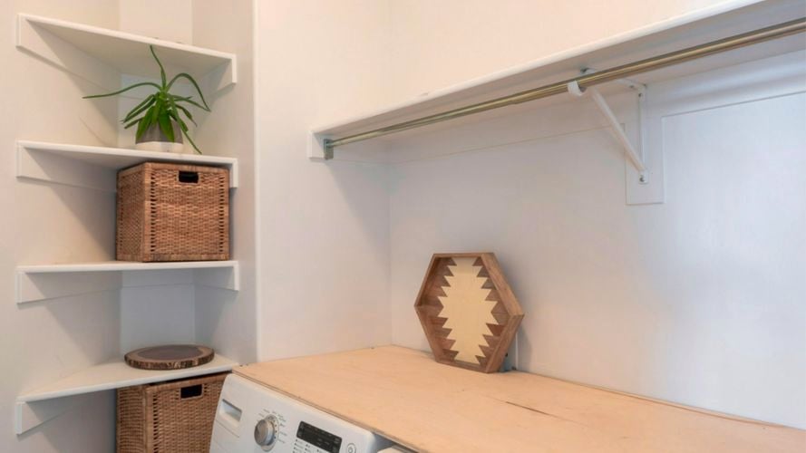 A laundry with shelving in it