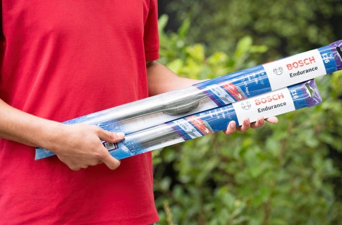 Holding two packets of windshield wiper blades 