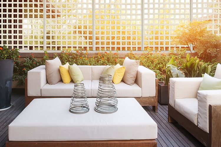 Backyard timber decking area with lounges and decorative lattice screening