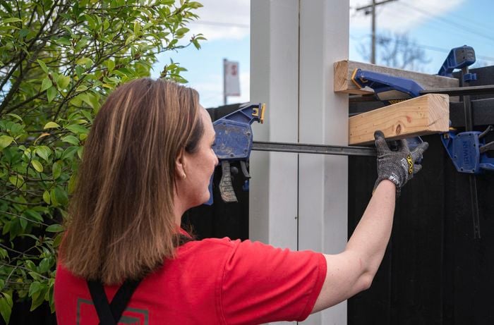 person using clamps to secure post