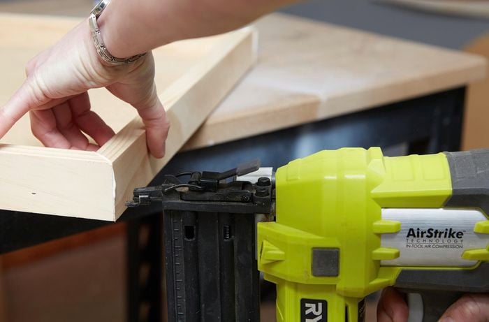 Person using nail gun to secure timber together