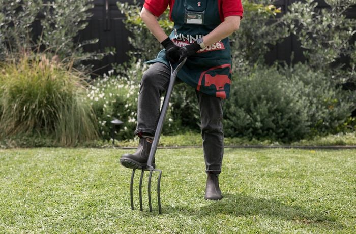 A man holding a garden fork.