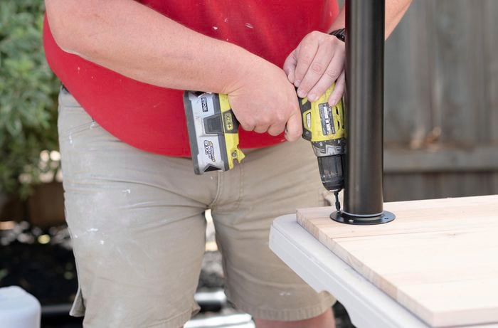 A Bunnings team member securing a table leg to a piece of timber