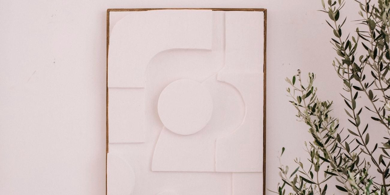 White artwork hung on wall