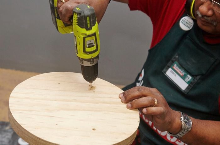 Holes being drilled into a stool seat
