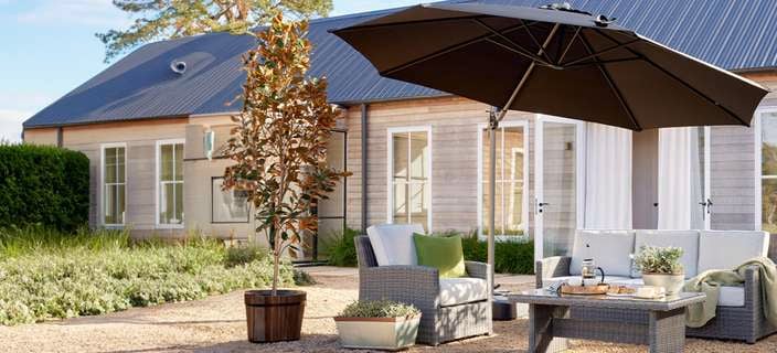 Wicker 3 piece setting with glass top table outdoor setting by Mimosa.