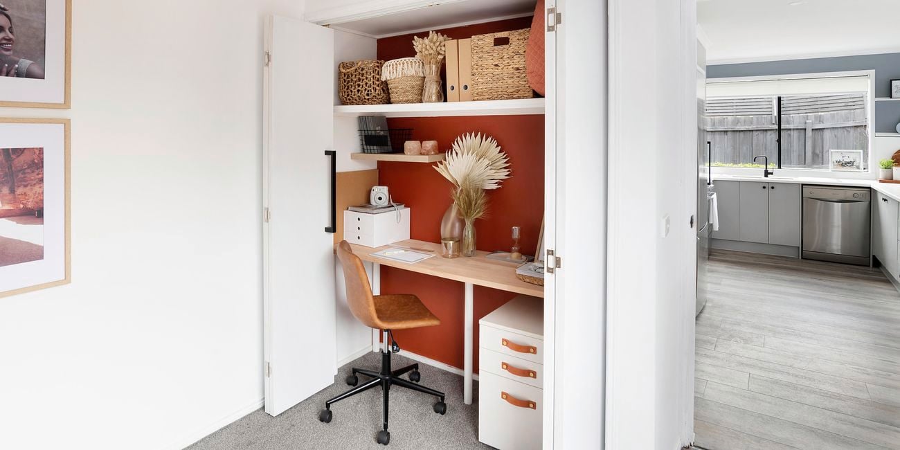 Office desk built into a cupboard.