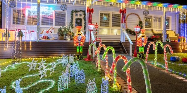 Front of house decorated with Christmas lights and decorations.