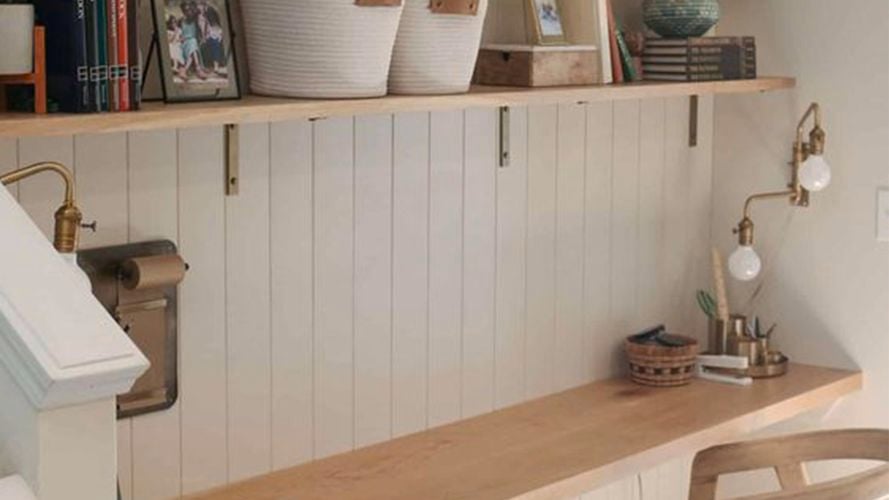 Home office with shelving on the wall