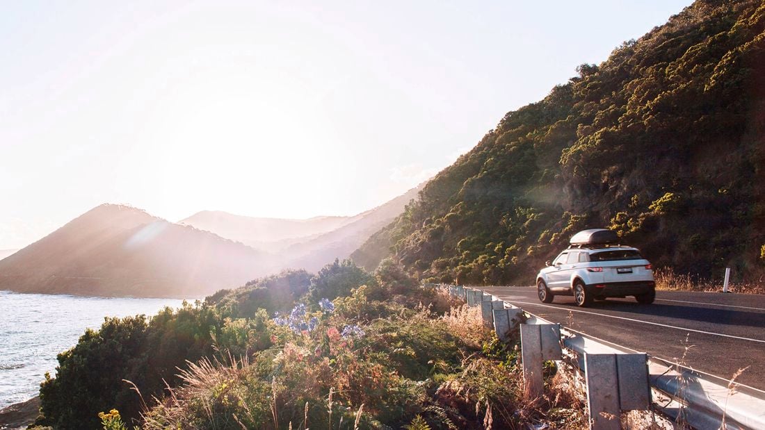 SUV ready for adventure on scenic highway ]