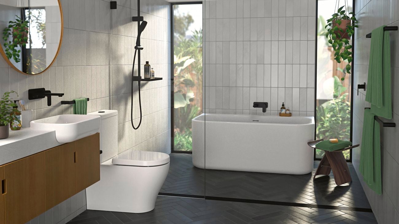 Modern bathroom featuring a Caroma toilet, bath, and tap mixers