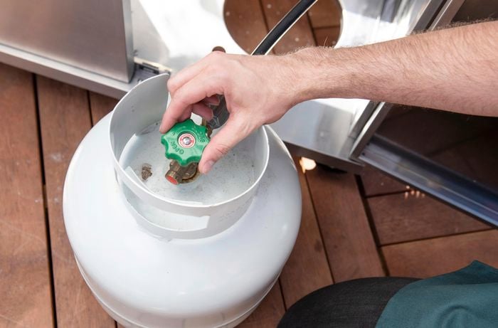 Turning the fittings of a BBQ gas bottle