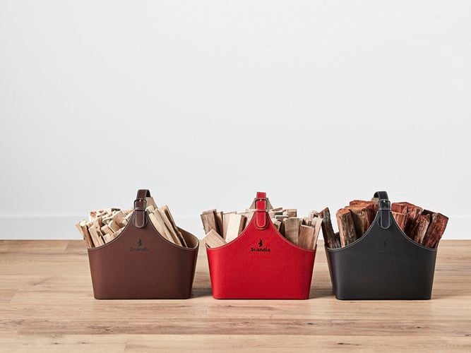 Different coloured bags containing lots of pieces of wood in them on timber flooring.