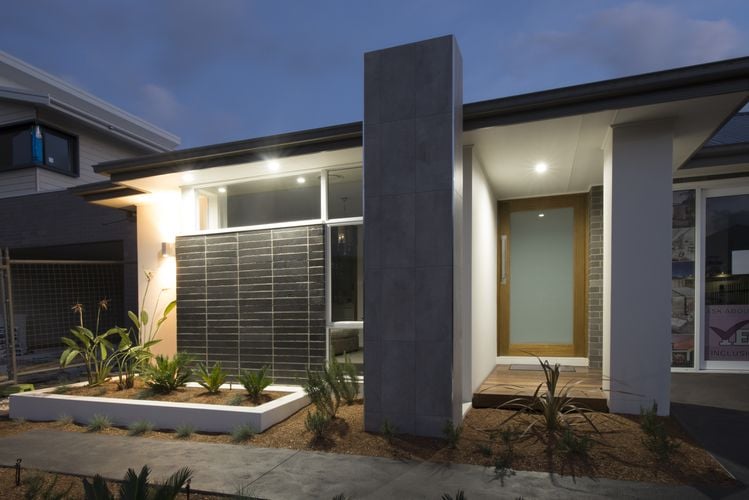 Front of a modern home, with timber and smoked glass front door