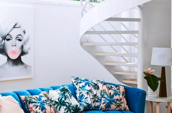 Teal couch and gold coffee table