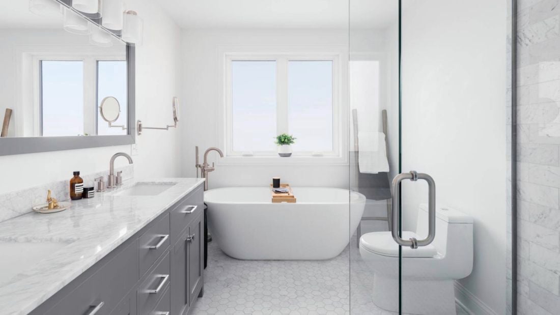 A modern white and grey bathroom with a curved freestanding bath and large stone-topped vanity