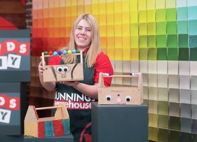 A Bunnings Team Member is holding a decorated tool caddy.