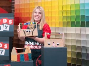A Bunnings Team Member is holding a decorated tool caddy.