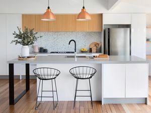 Grey and white kitchen with timber cabinets and rose gold pendant lights