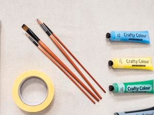 Tubes of craft paint and paint brushes
