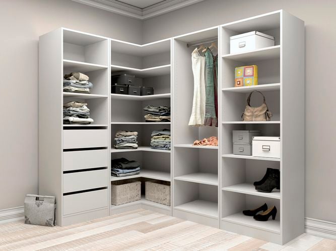 A corner wardrobe next to a wall with clothes and shoes in it