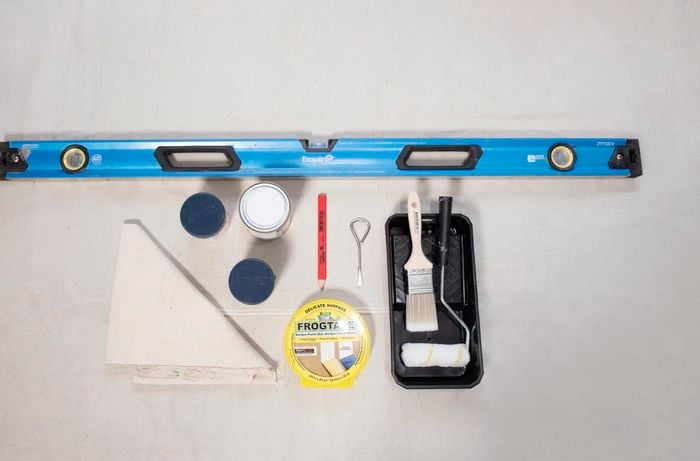 Spirit level, paint, drop sheet, paint brush and roller, paint try.