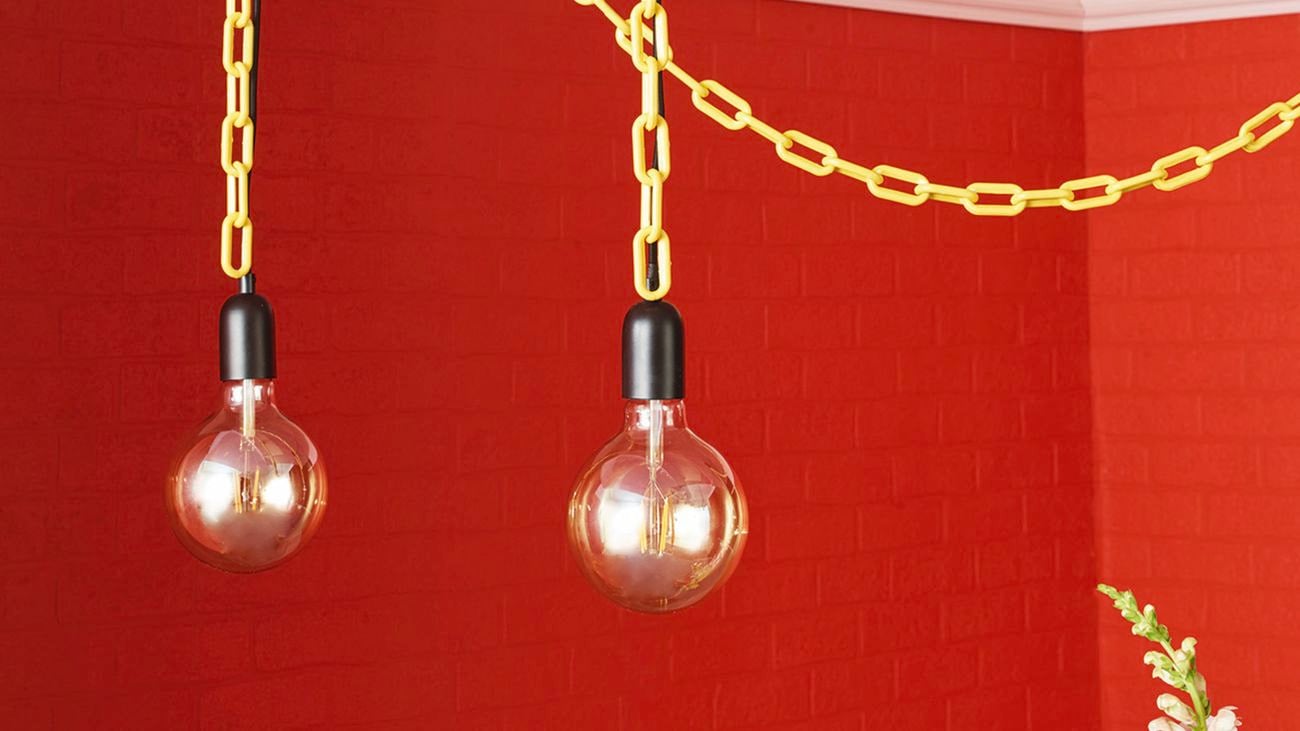 Two lightbulbs hanging from roof with yellow chain.
