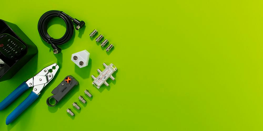 Bright green background with antenna accessories laid out on left corner
