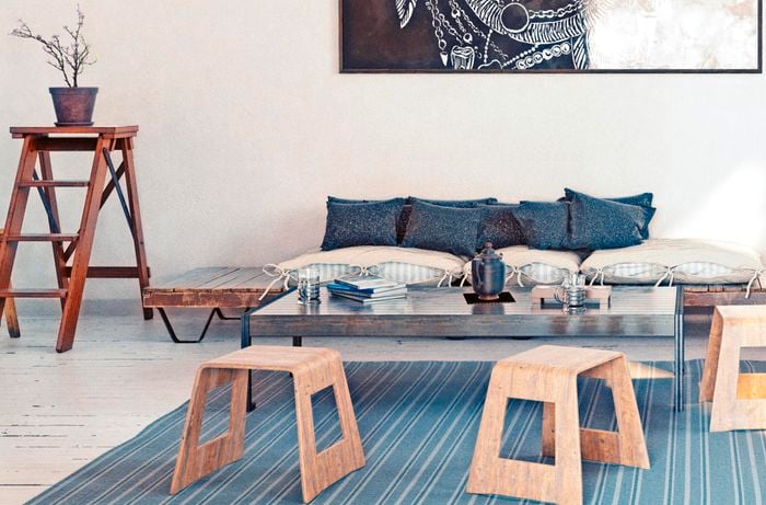 Living room with couch, coffee table and assorted decorative items.
