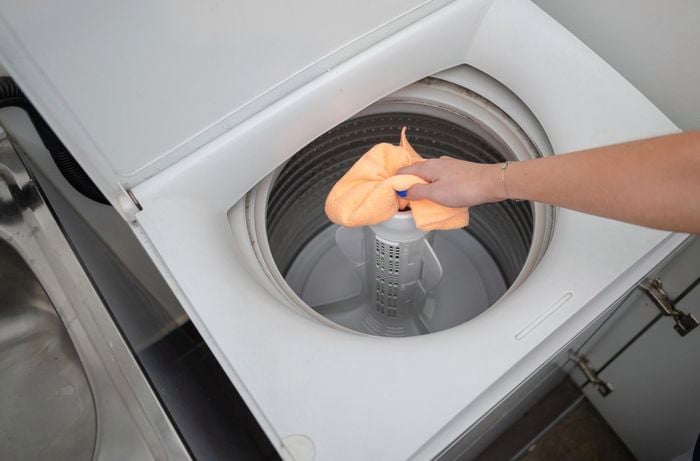 Removing existing residue inside the washing machine using a cloth.
