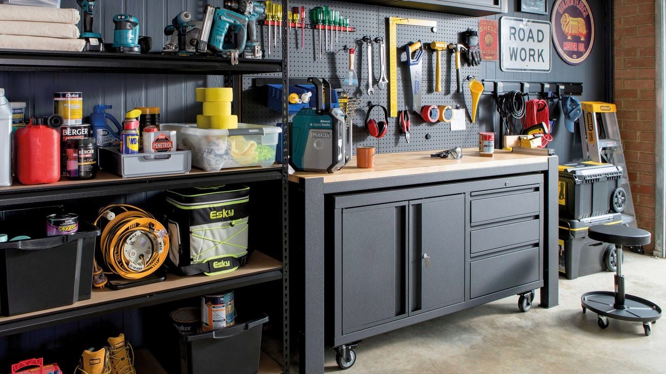 Various shelving and cabinets installed around a garage work bench