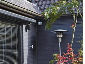 Outdoor sitting with gas heater in garden